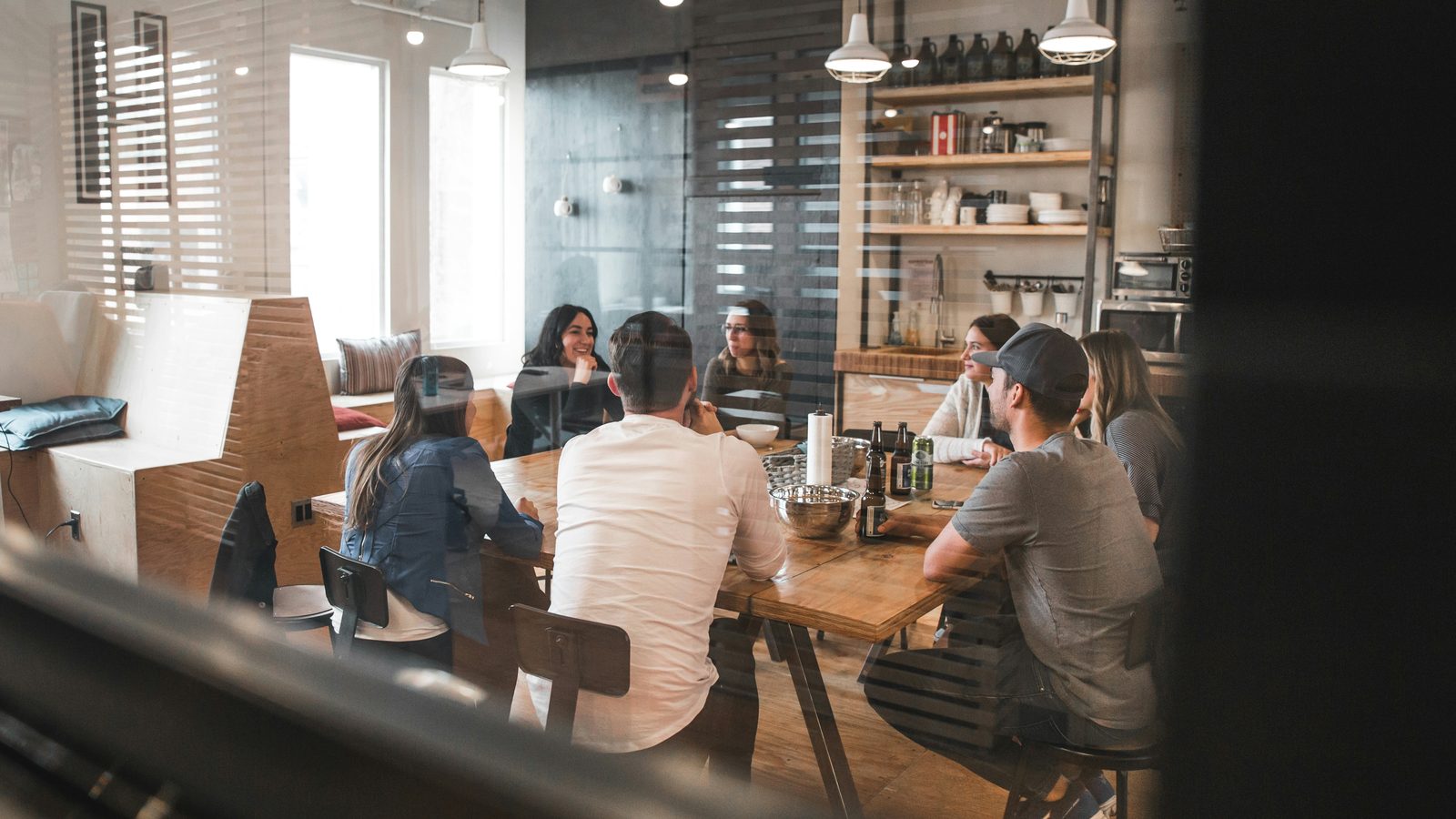 Ujamii team members in conversation around a table during a strategy meeting